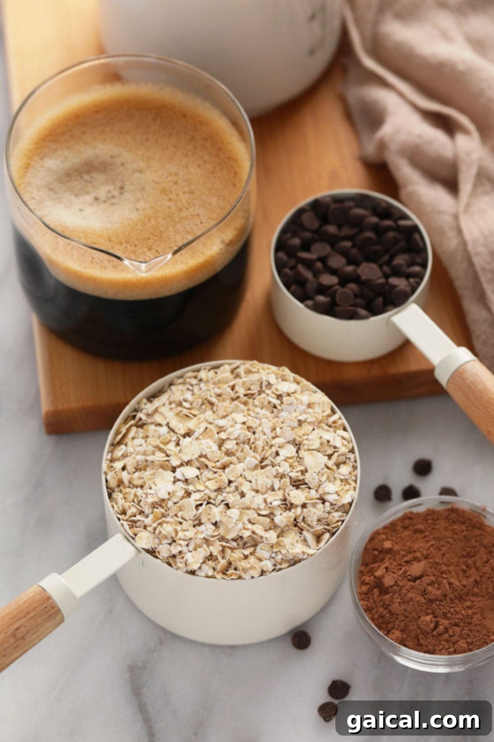 A selection of fresh ingredients neatly arranged, ready to be mixed for Quick Mocha Overnight Oats, including oats, chia seeds, coffee, and chocolate chips.