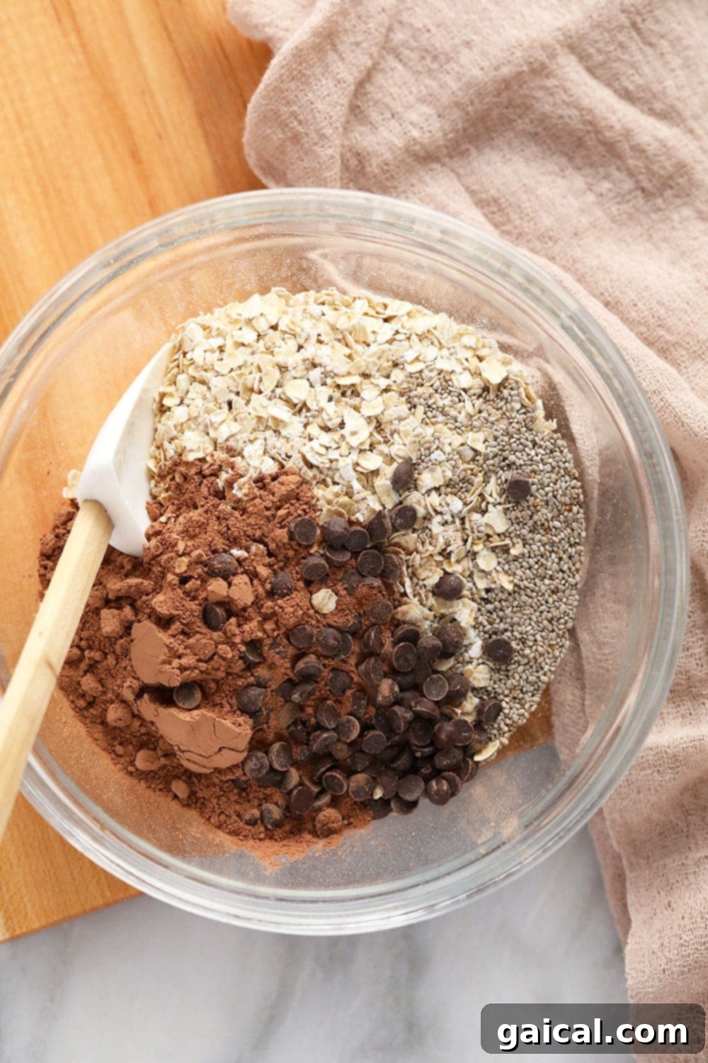 Dry ingredients for Quick Mocha Overnight Oats, including quick-cooking oats, cocoa powder, and chia seeds, neatly mixed in a bowl before adding liquids.
