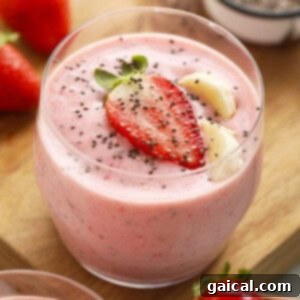 A refreshing chia seed smoothie blended with fresh strawberries and bananas in a glass.