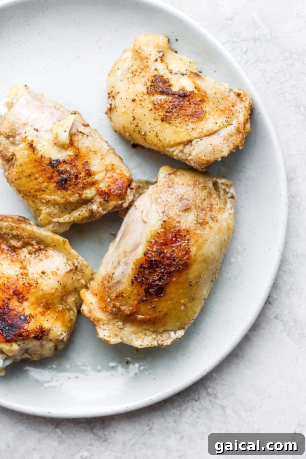 Achieve perfectly cooked, crunchy sous vide bone-in chicken thighs with this foolproof recipe! Crispy Sous Vide Chicken Thighs served on a plate with vibrant side dishes, showcasing golden-brown skin