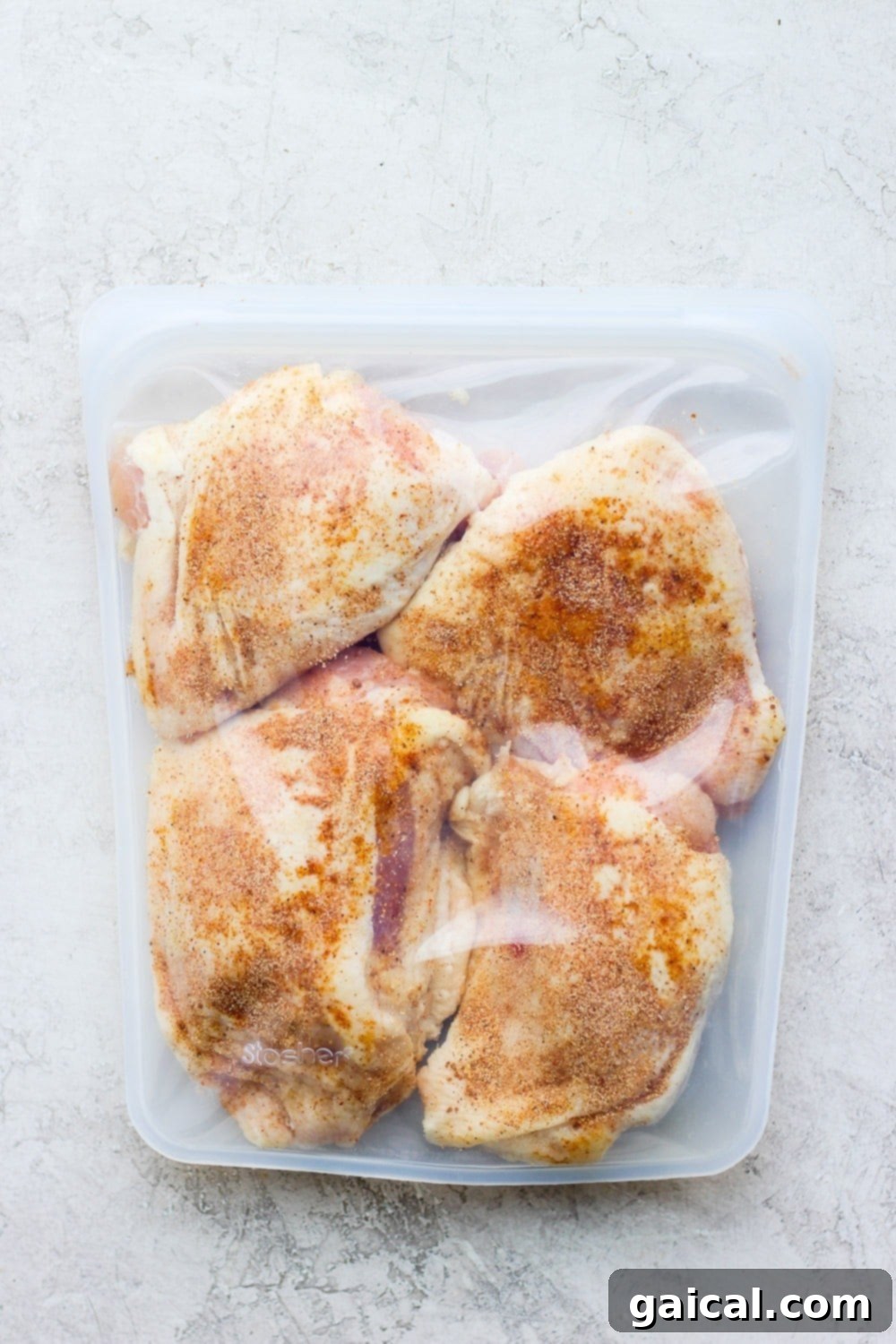 Chicken thighs prepared in a Stasher bag for sous vide immersion. Seasoned chicken thighs sealed in a Stasher bag, ready for sous vide cooking