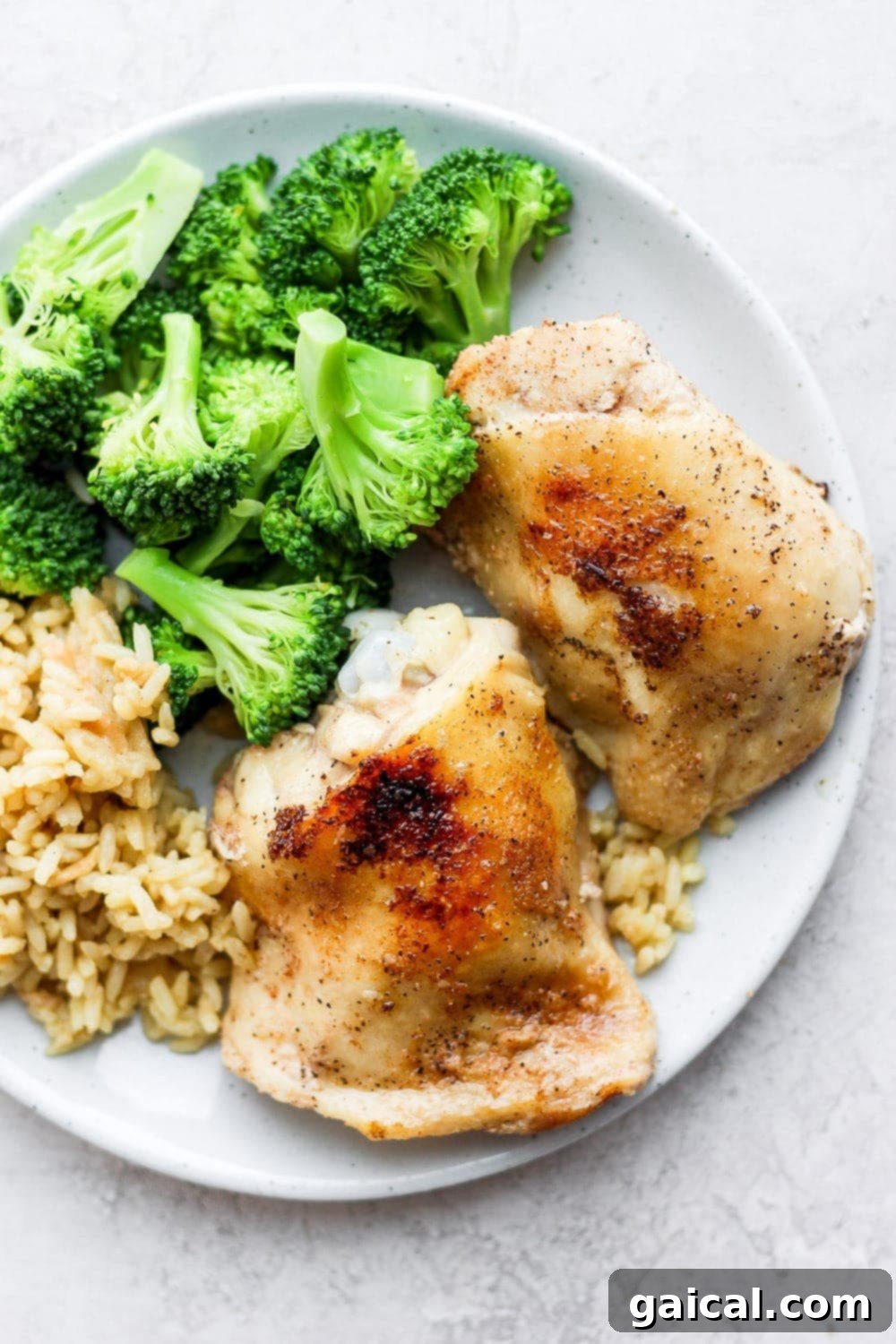 Golden-brown sous vide chicken thighs: a perfect weeknight meal with rice and broccoli. Crispy sous vide chicken thighs served beautifully on a plate with brown rice and fresh broccoli florets