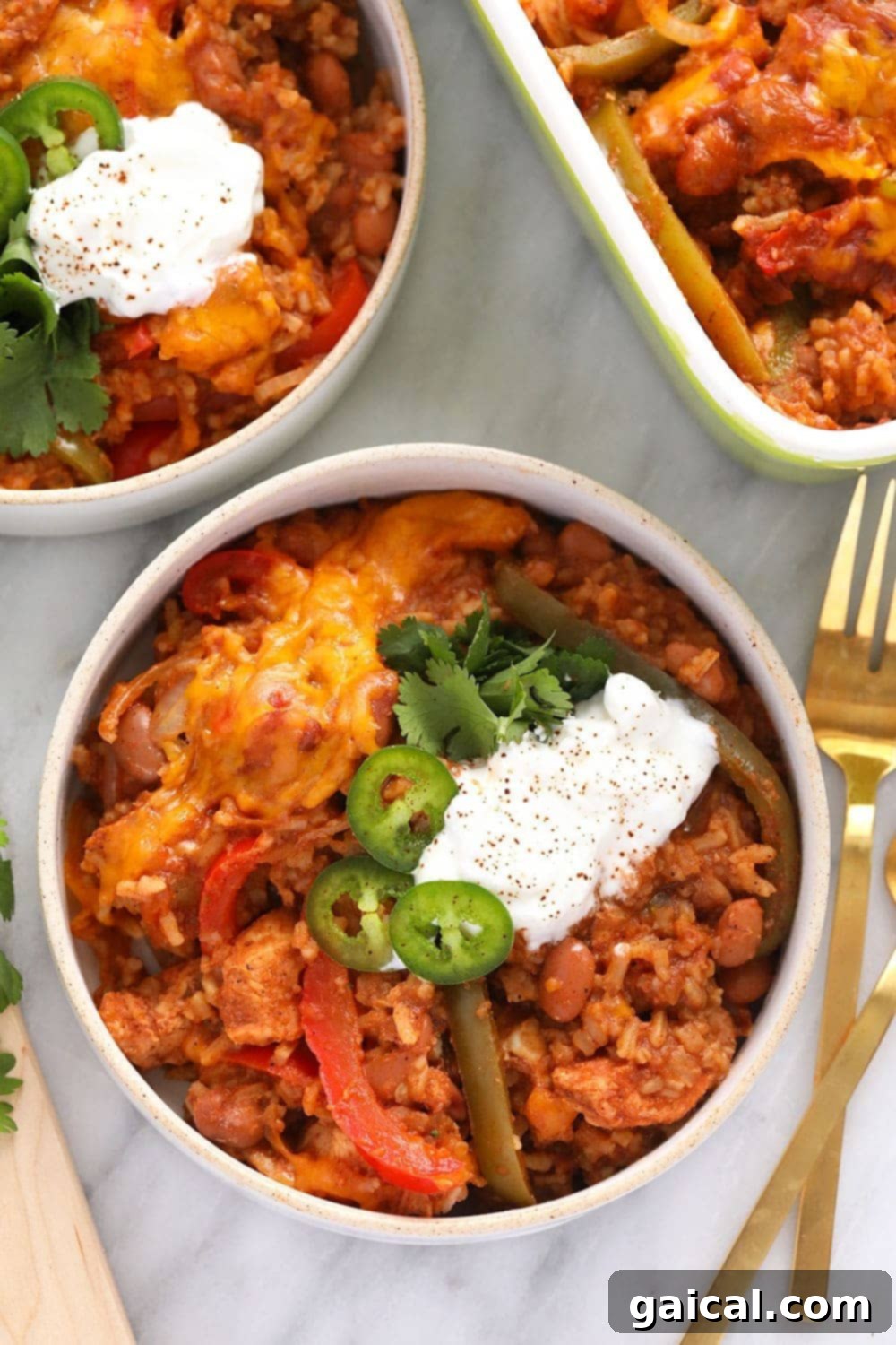 Healthy Chicken Burrito Bowl Casserole in a rustic bowl, garnished with fresh jalapeños and Greek yogurt