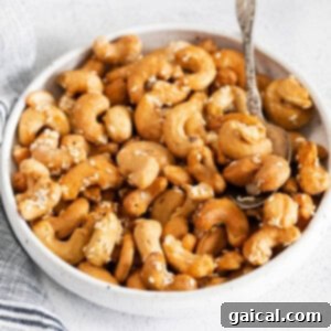 Roasted cashews in a bowl with sesame seeds, ready to be served as a delightful snack.