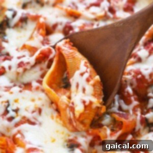 A wooden spoon is being used to scoop up a stuffed pizza.