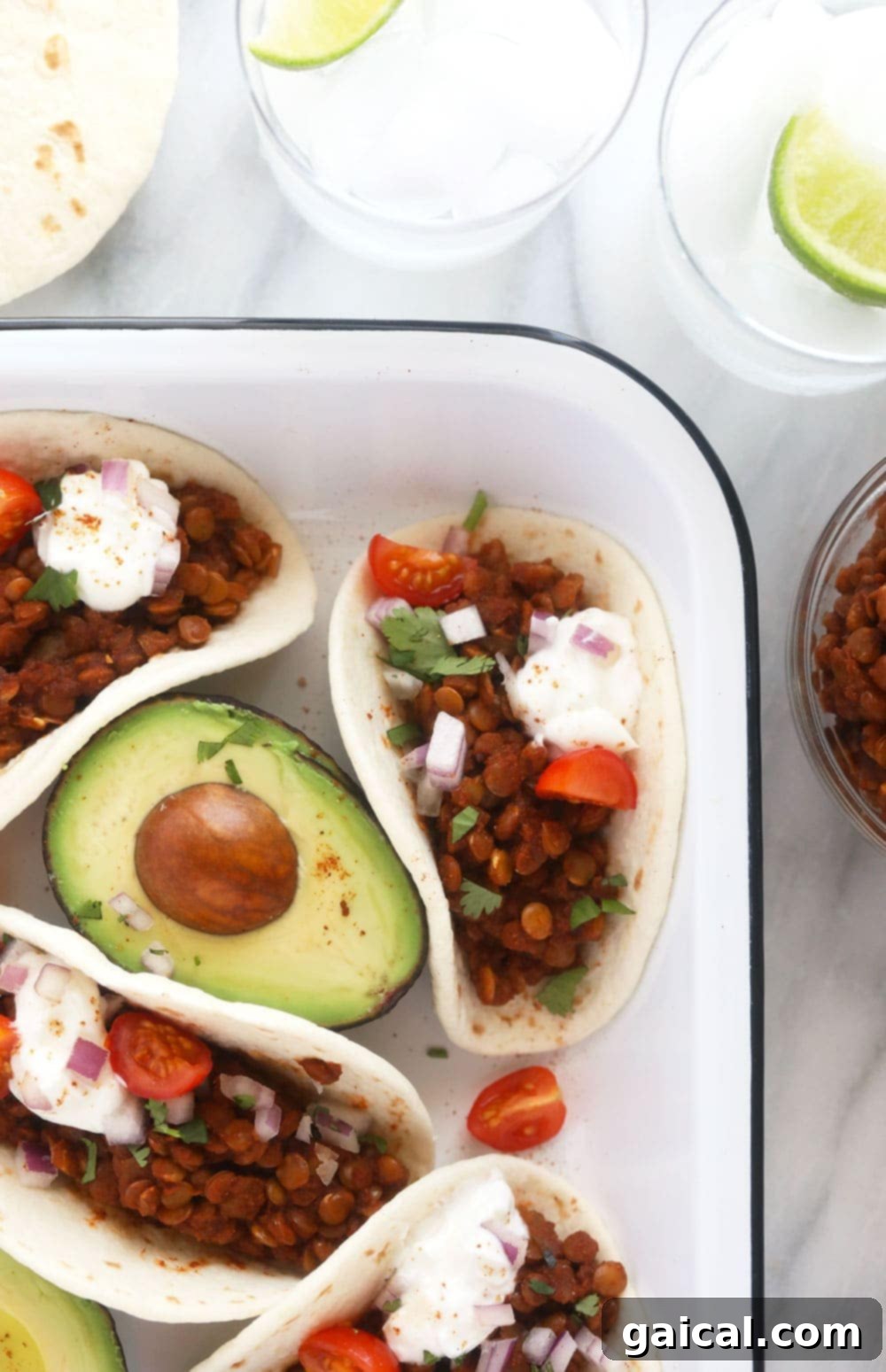 Instant Pot Lentil Tacos Ready to Serve A close-up of a serving of Instant Pot Lentil Tacos, topped with fresh avocado and cilantro, highlighting its appealing texture and vibrant colors.