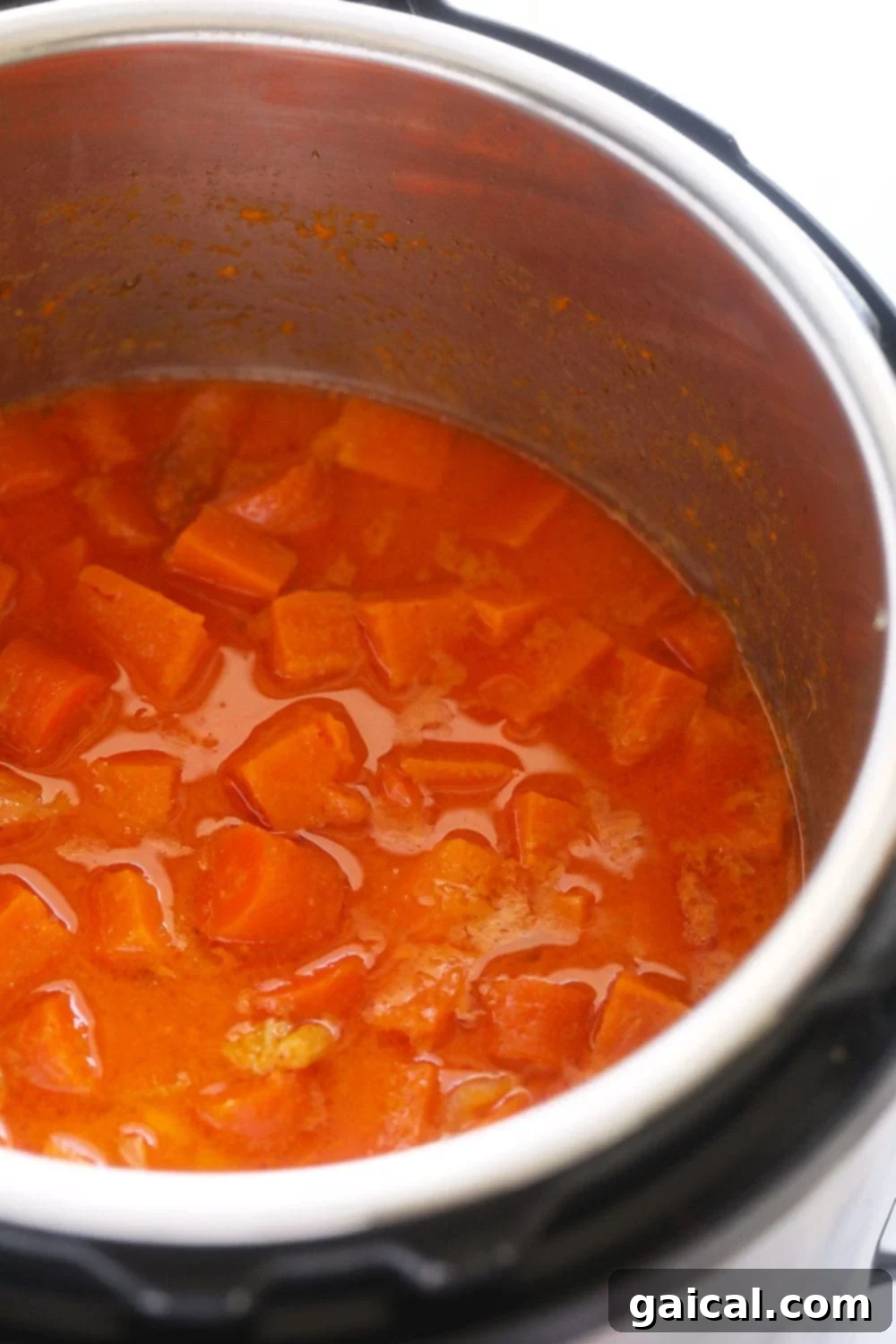 Instant Pot Sweet Potato Carrot Ginger Soup, blended and ready to serve, shown inside the Instant Pot.