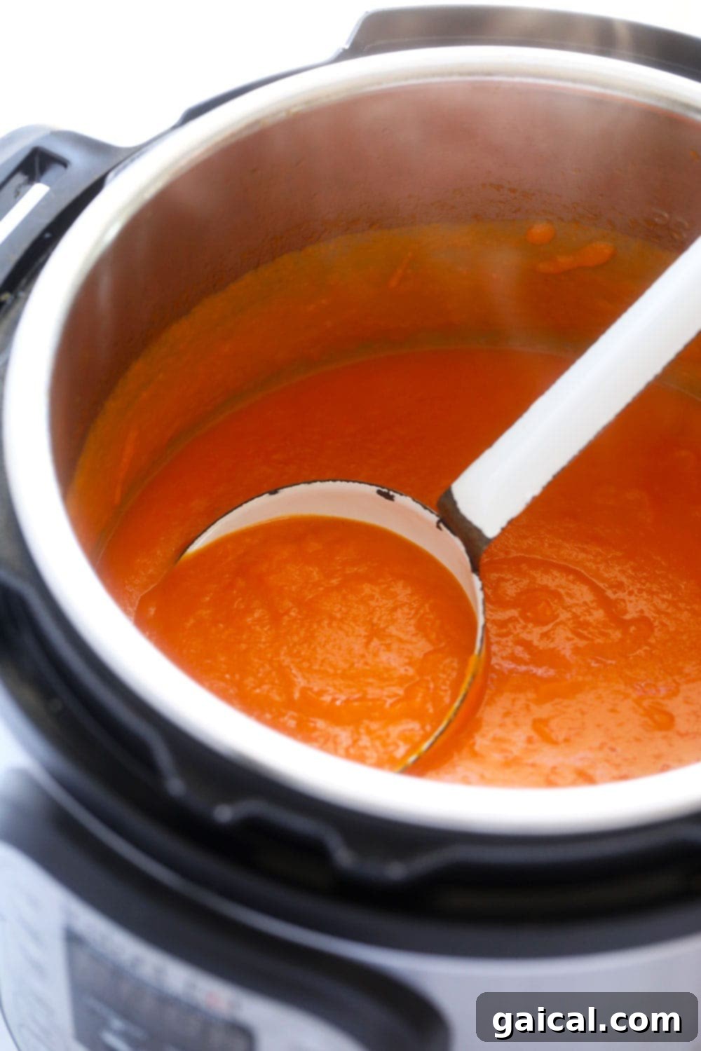 The Instant Pot Sweet Potato Carrot Ginger Soup freshly blended and smooth, ready to be ladled into bowls.