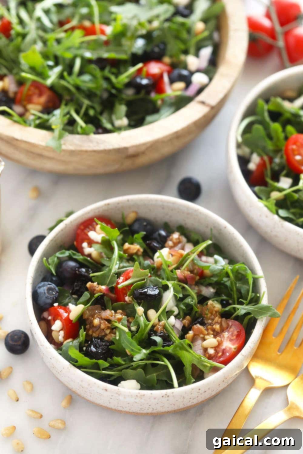 This arugula salad has dried fruit, vegetables, cheese, and a delicious dressing! It is the best arugula salad out there. It is perfect for a meal prep lunch or a great addition to any dinner! A small, perfectly portioned arugula salad in a minimalist bowl, artfully arranged and ready to be served, perfect as a light lunch or elegant side.