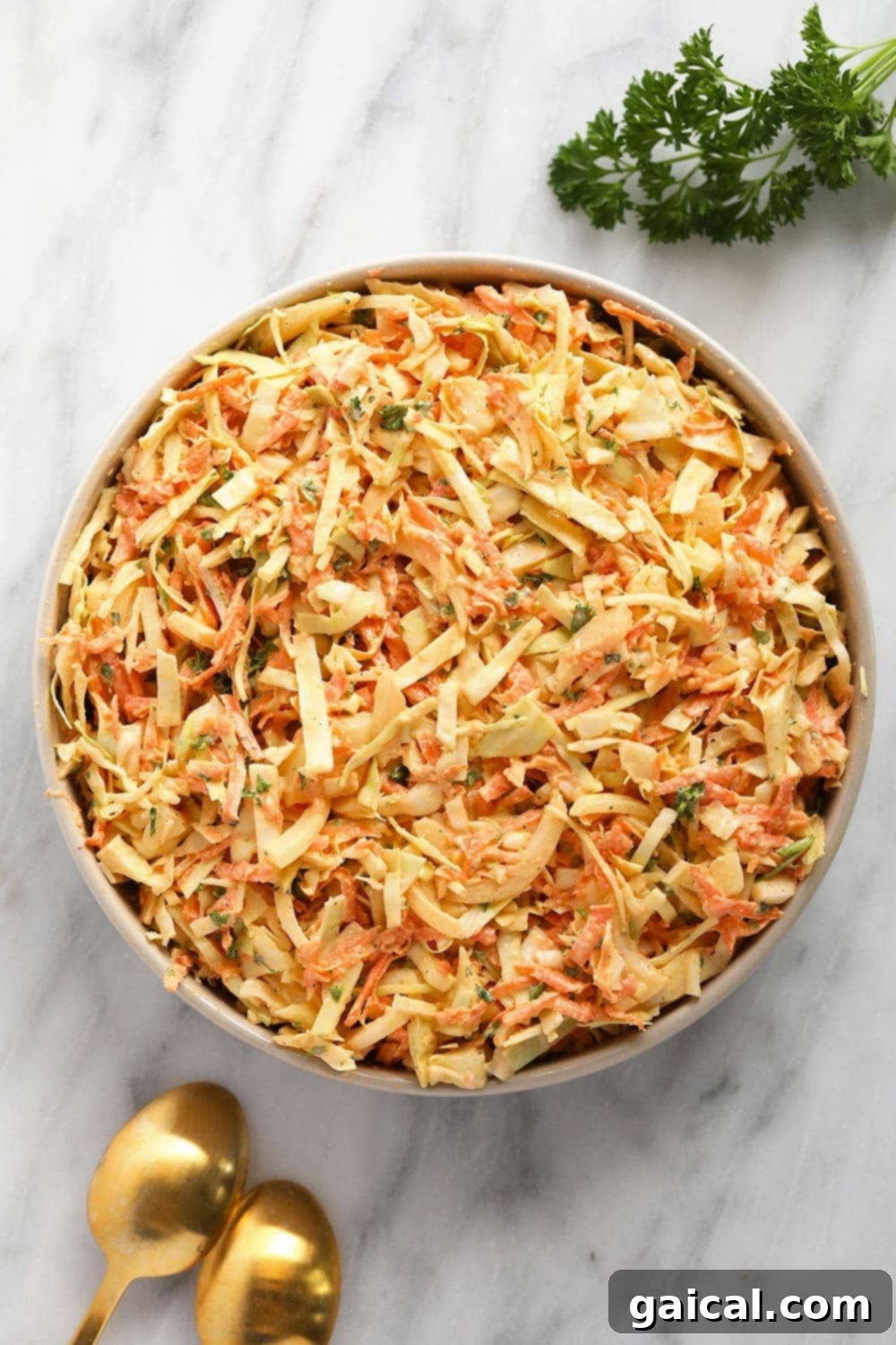This Creamy Coleslaw Recipe is the perfect summer side dish for your next backyard BBQ! creamy coleslaw in a bowl ready to be served