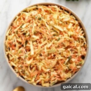 creamy coleslaw in a bowl topped with parsley