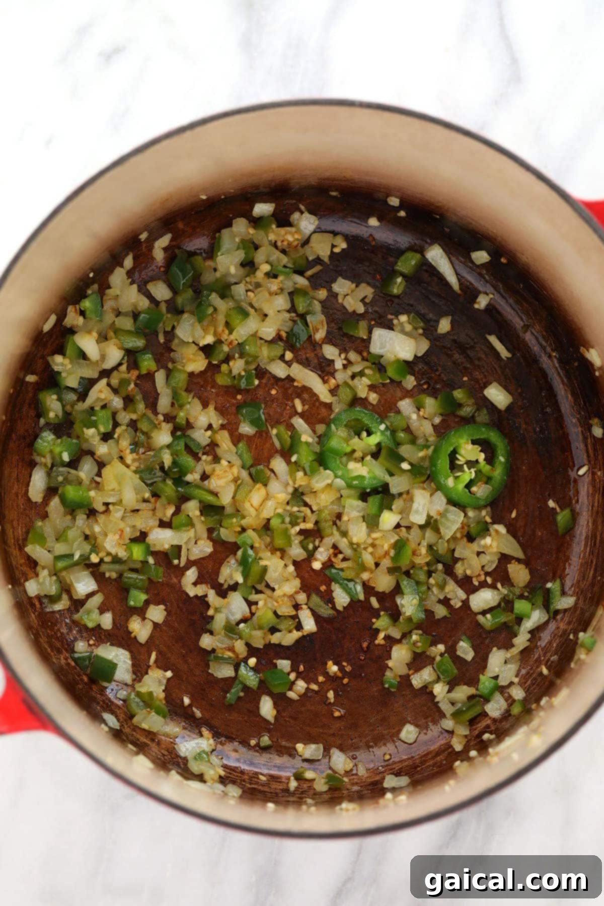 Wholesome Quinoa Mac 3 Freshly minced jalapeños, onions, and garlic gently sautéing in a Dutch oven, forming the aromatic base for the rich cheese sauce.
