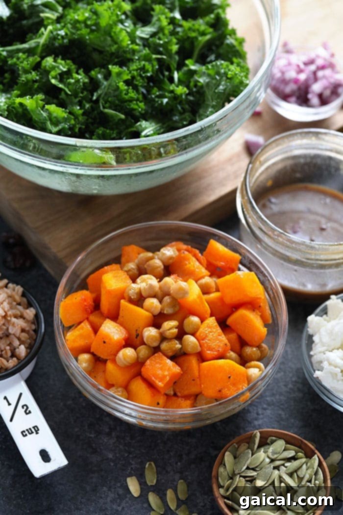 Roasted butternut squash and chickpeas in a bowl, ready to be added to the farro salad.