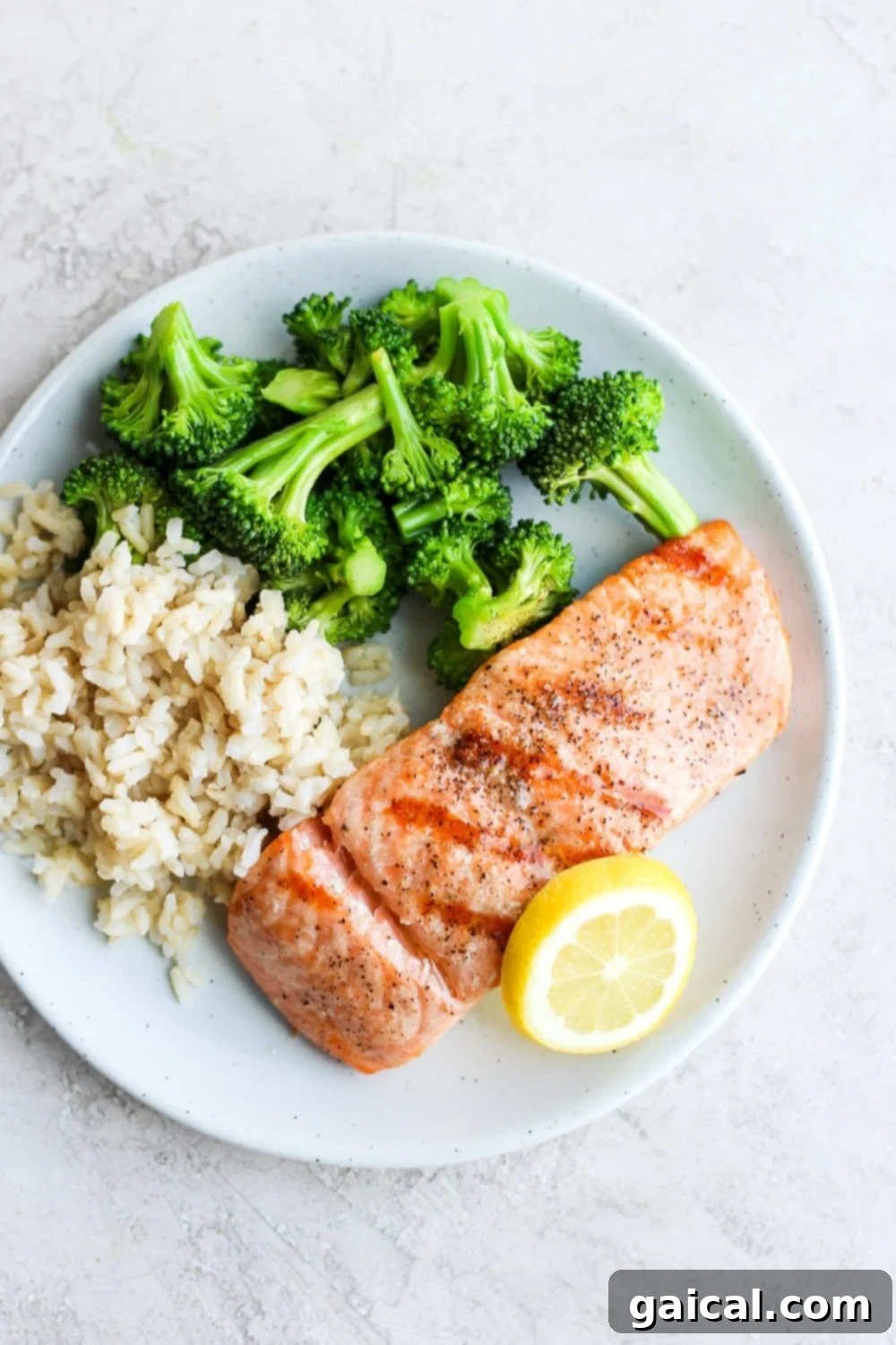 Perfectly grilled salmon fillet served on a plate with vibrant green broccoli florets and fluffy white rice, showcasing a healthy and delicious meal.