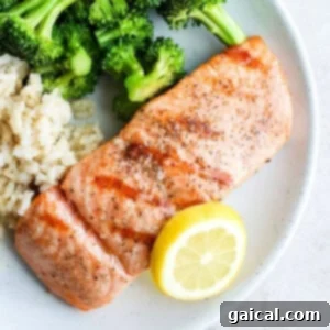 A beautifully grilled salmon fillet served on a plate, showcasing its golden-brown sear and flaky texture, ready to be enjoyed as a gourmet meal.