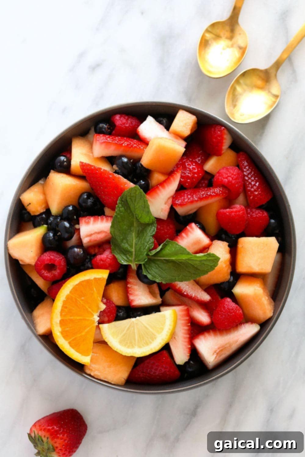 This fruit salad recipe makes for a healthy and flavorful summer side dish or kid-friendly snack! Made from fresh fruit and a 2-ingredient homemade dressing, this fruit salad is ready to enjoy in 15 minutes tops! fresh fruit salad in a bowl ready to be served
