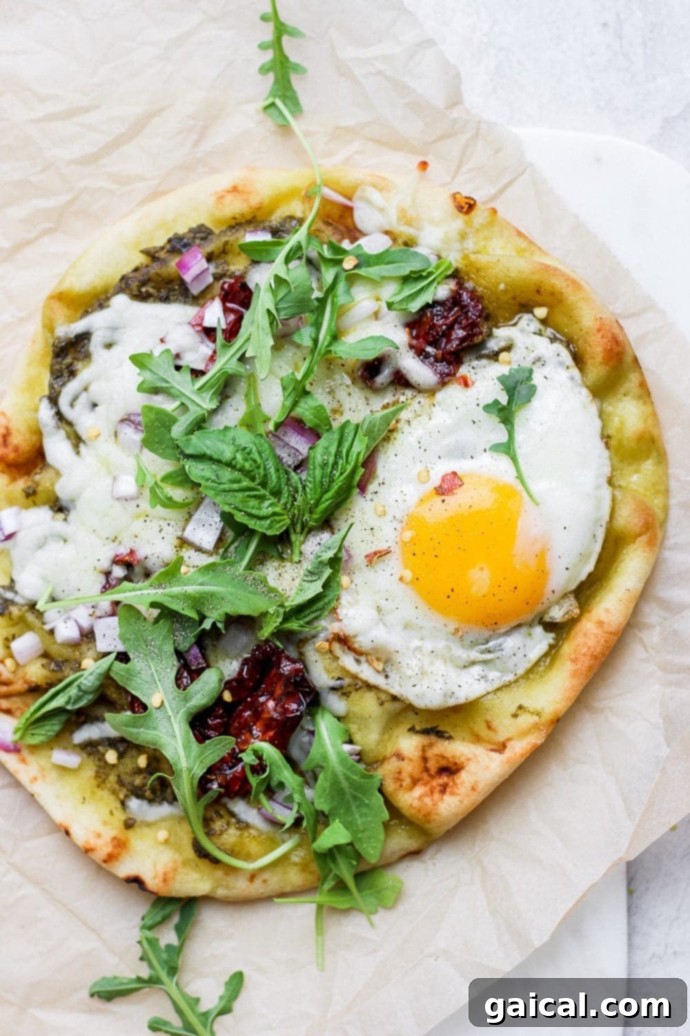 Naan Breakfast Bake 2 Naan breakfast pizza on a plate, ready to be enjoyed.