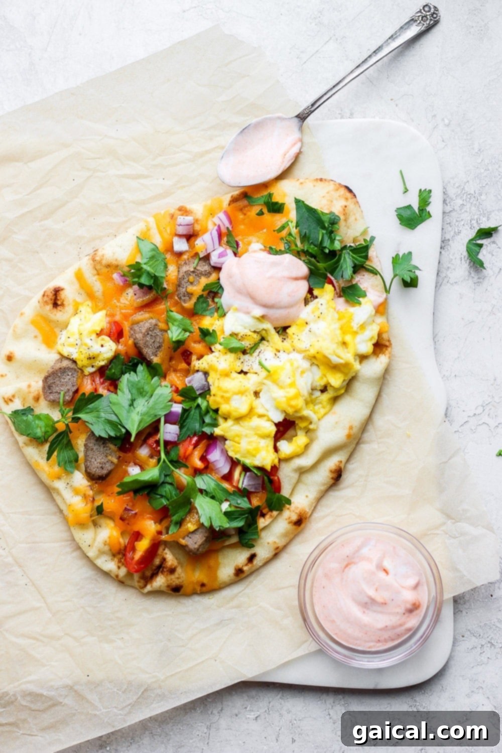 Naan Breakfast Bake 7 Another view of the delicious naan pizza topped with chicken sausage, eggs, tomatoes, and red onion.