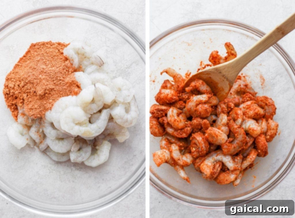 Raw shrimp being coated generously in a vibrant taco seasoning, preparing for cooking.
