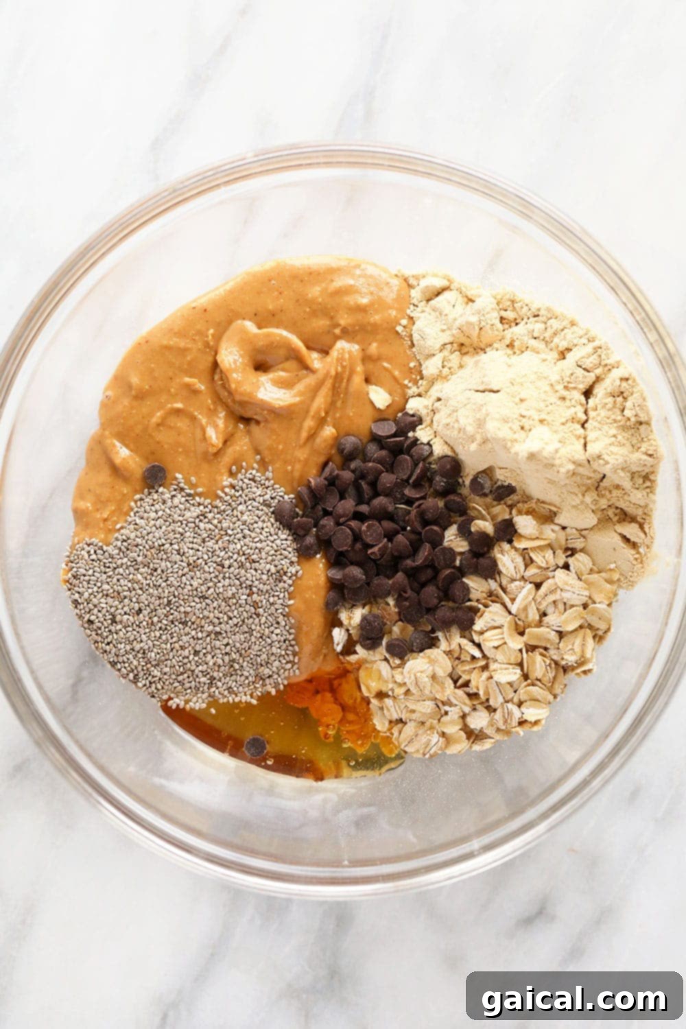 Gather Your Ingredients for the Best Peanut Butter Protein Balls All the raw ingredients for peanut butter protein balls laid out on a wooden surface.