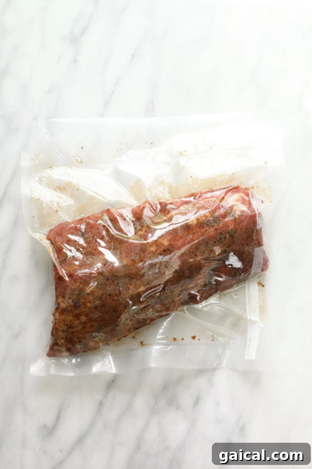These bbq ribs are rubbed with a smokey dry rub, cooked in a sous vide bath for 24 hours, slathered with BBQ sauce, and then grilled to perfection. Sous vide ribs in a food savor bag.