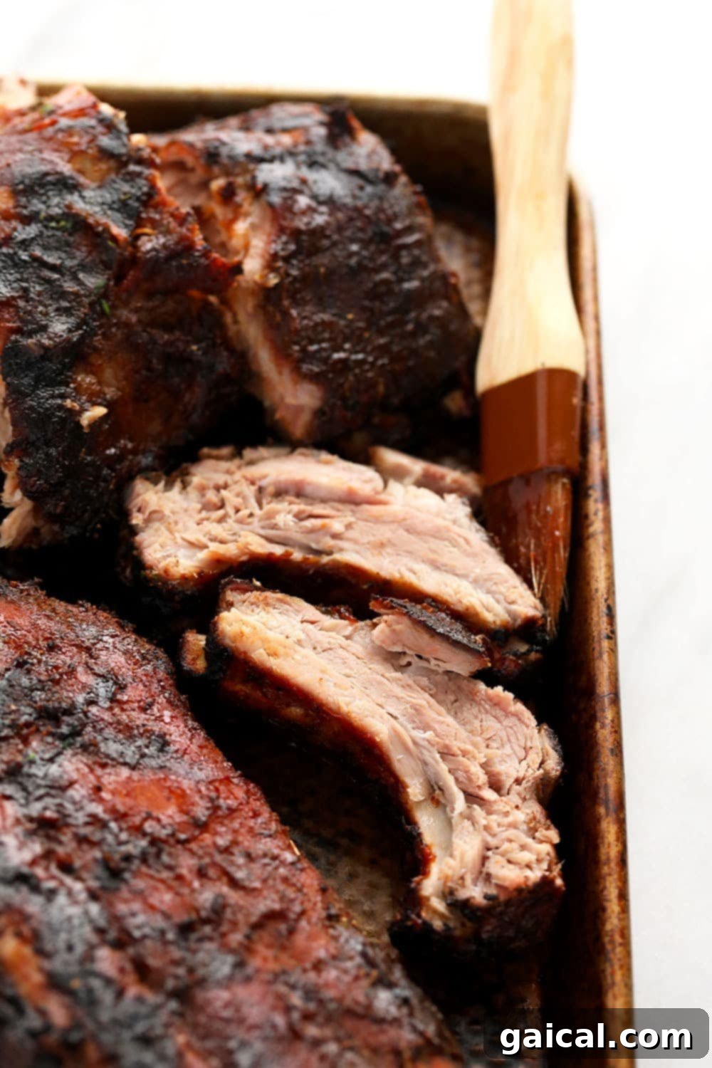 It's time for you to make our 24-hour, ultra-tender, fall-off-the-bone sous vide ribs! These bbq ribs are rubbed with a smokey dry rub, cooked in a sous vide bath for 24 hours, slathered with BBQ sauce, and then grilled to perfection. Sous vide ribs ready to eat!