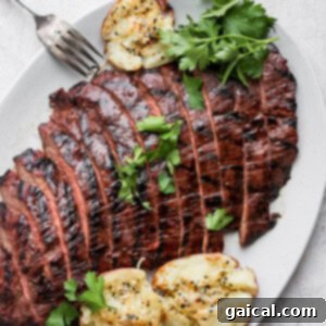 Grilled flank steak on a plate.