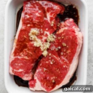 Seared Flank Perfection 2 steak in casserole dish with marinade