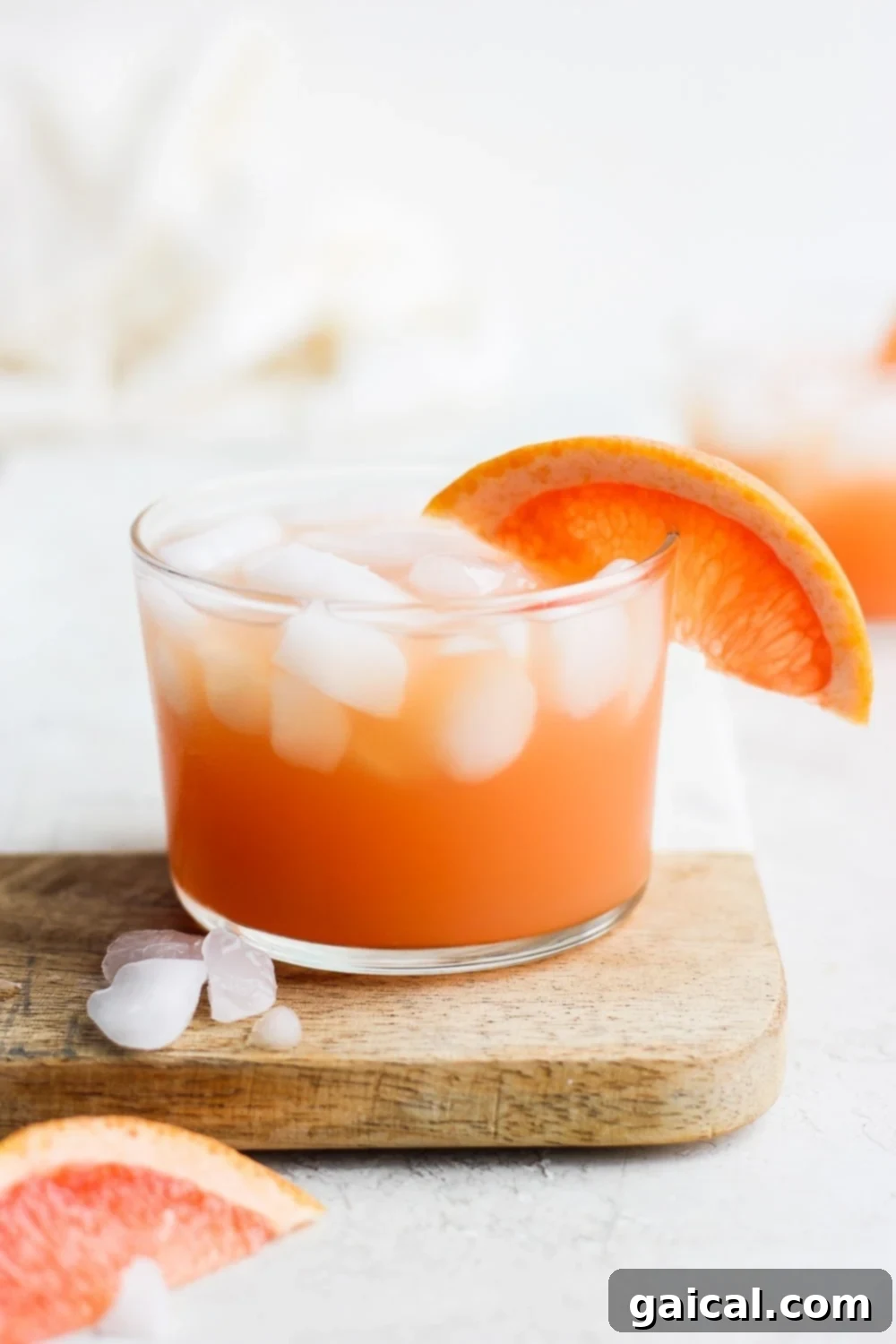 Refreshing Grapefruit Paloma Cocktail A vibrant Paloma cocktail garnished with a fresh grapefruit slice on the rim of the glass, ready to be enjoyed.