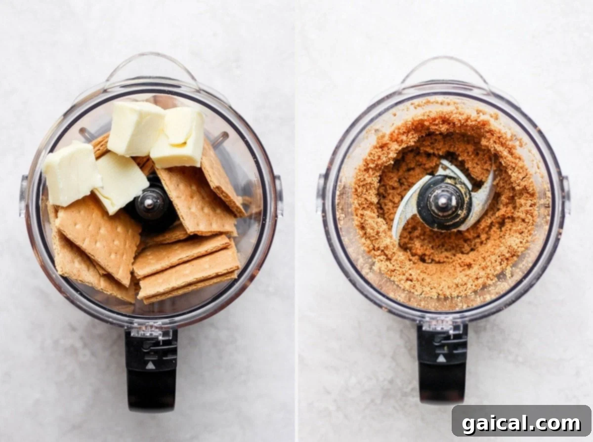 Graham cracker crumbs and butter being processed in a food processor, forming the base for the blueberry cheesecake bars.