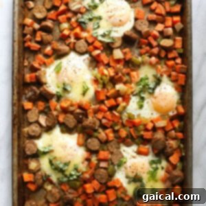 The completed sweet potato hash with baked eggs, some topped with melted cheese, fresh out of the oven.