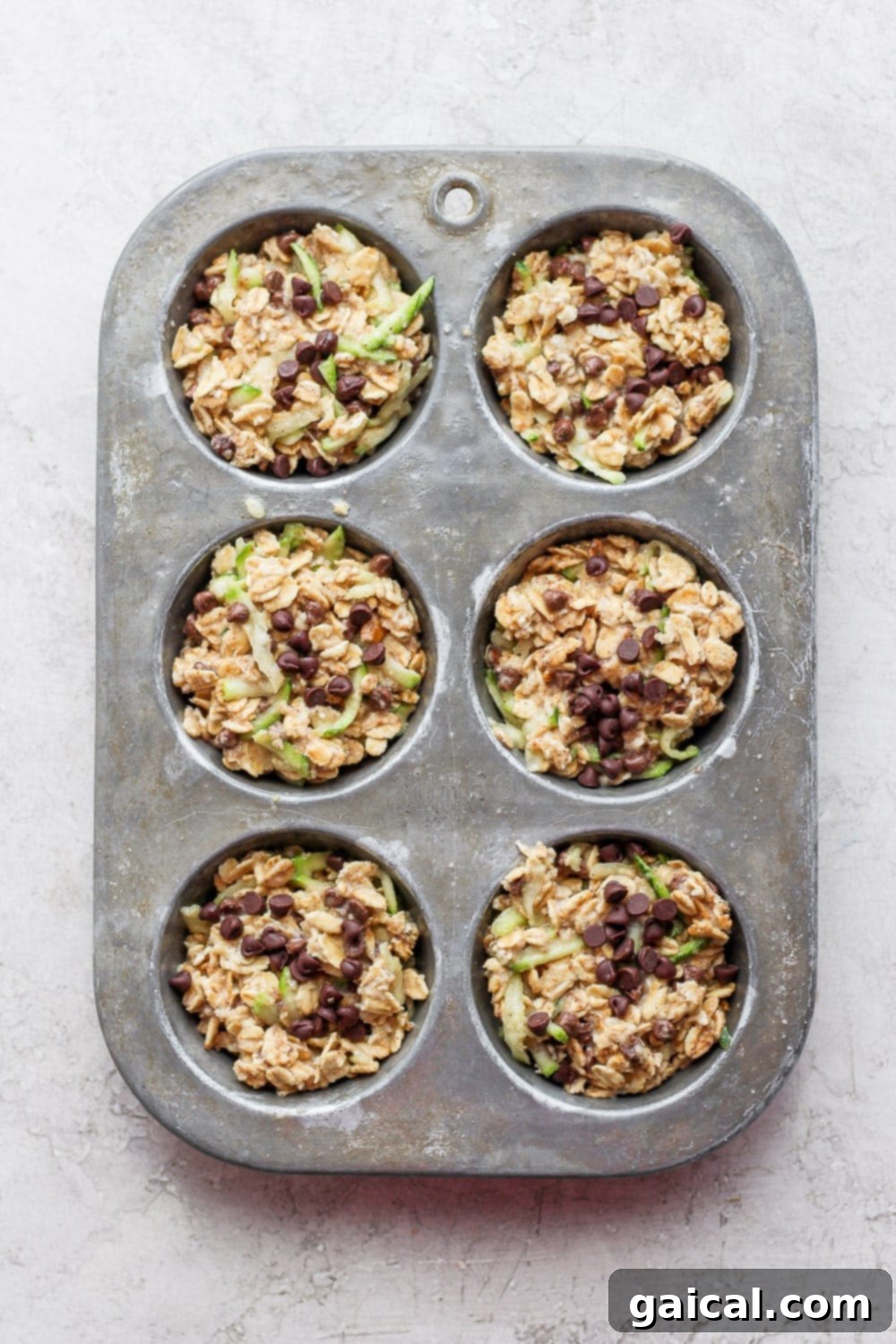Zucchini oatmeal cups in a muffin tin. 