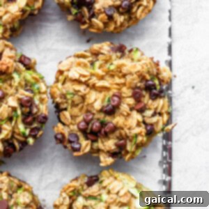 zucchini chocolate chip muffins on a baking sheet.