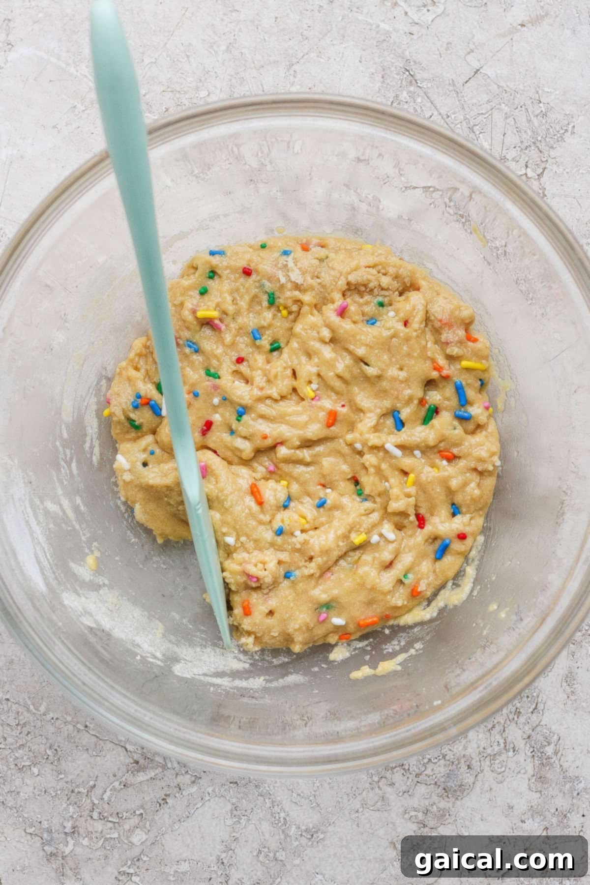 Protein-Packed Sugar Cookie Bites 3 Raw cookie dough in a bowl with sprinkles.