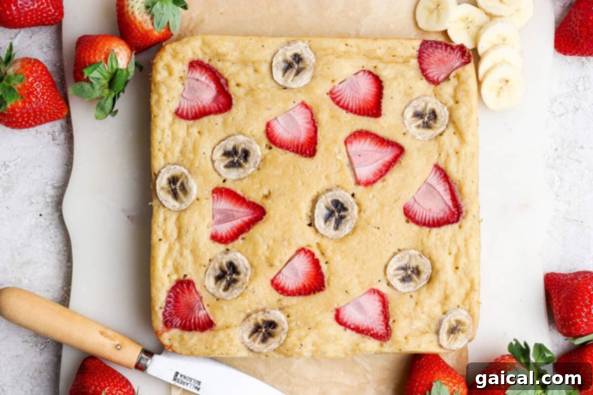 Strawberry Banana Cottage Cheese Breakfast Bake topped with fresh strawberries and bananas