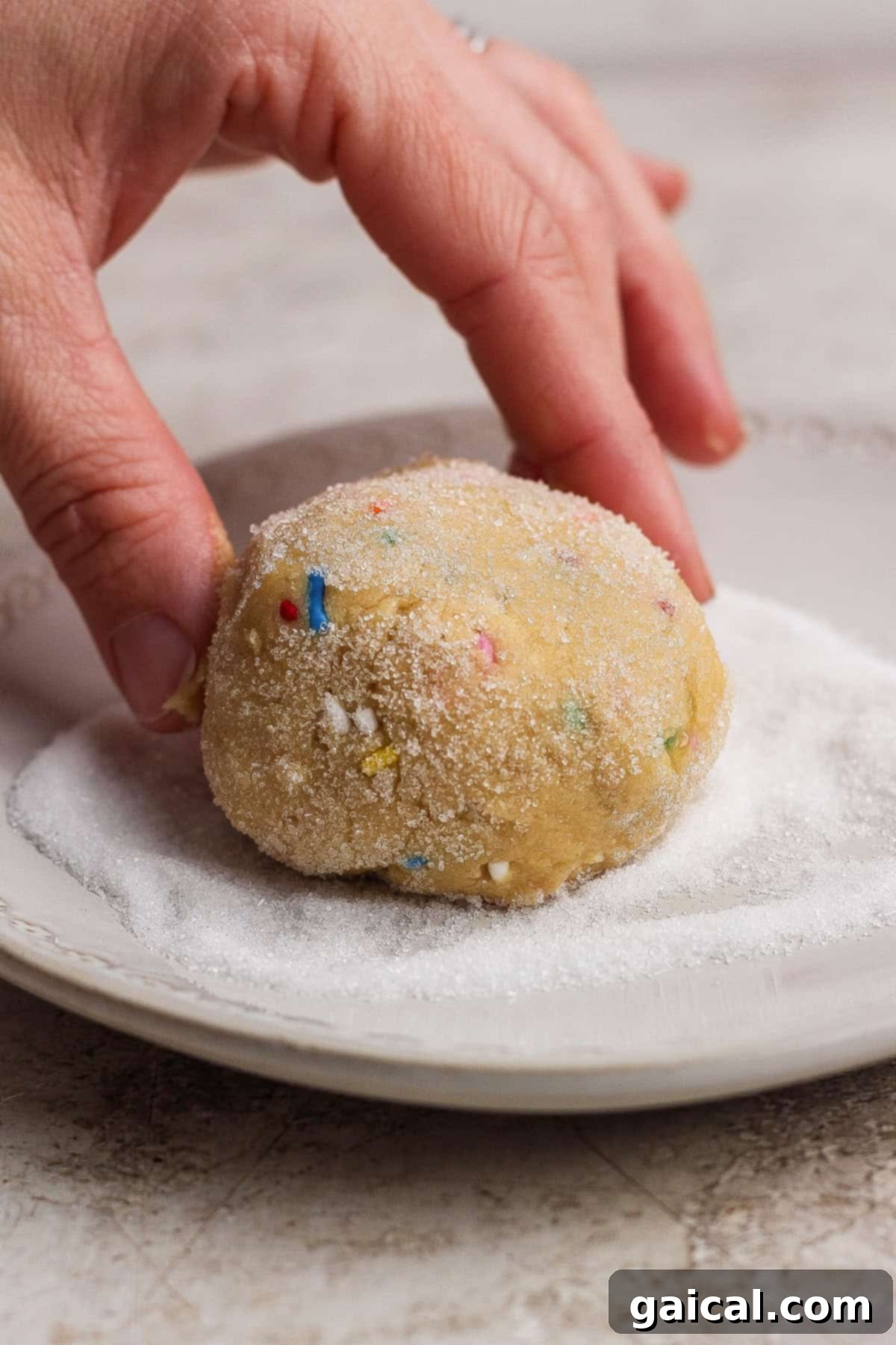 Rolling cookie dough in sugar
