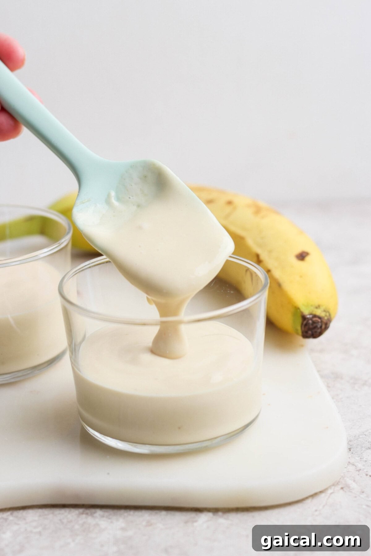 High-Protein Banana Dream 4 Creamy banana pudding being scooped from a glass