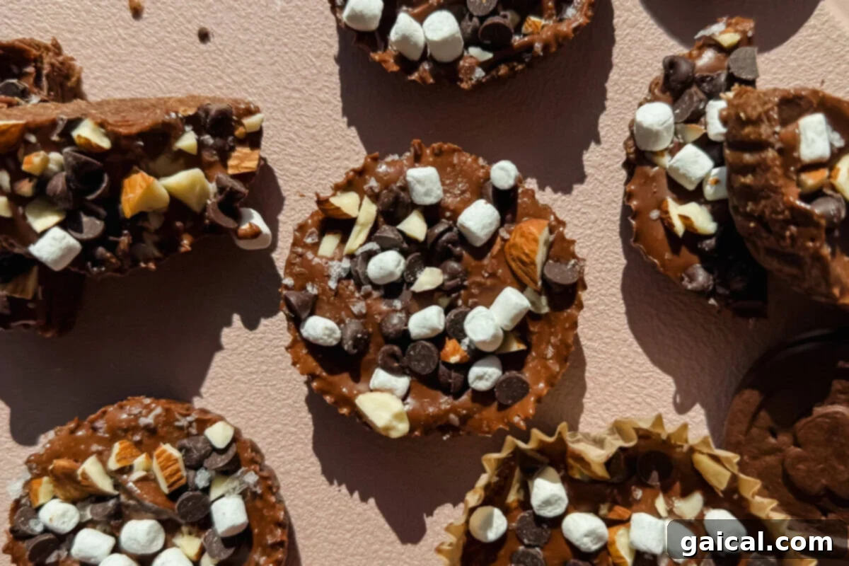Delicious Exploremore Oat Cups topped with marshmallows, chocolate chips, and almonds