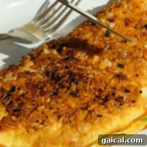 Folding the crispy rice omelette
