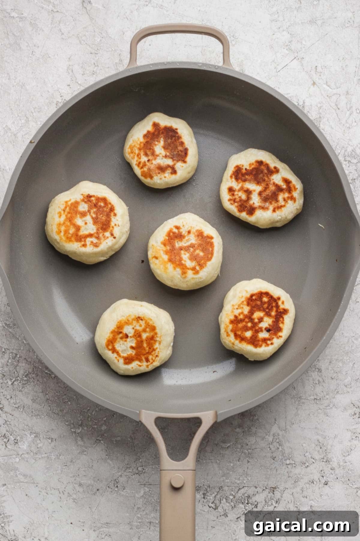Cooking the stuffed English muffins in a skillet