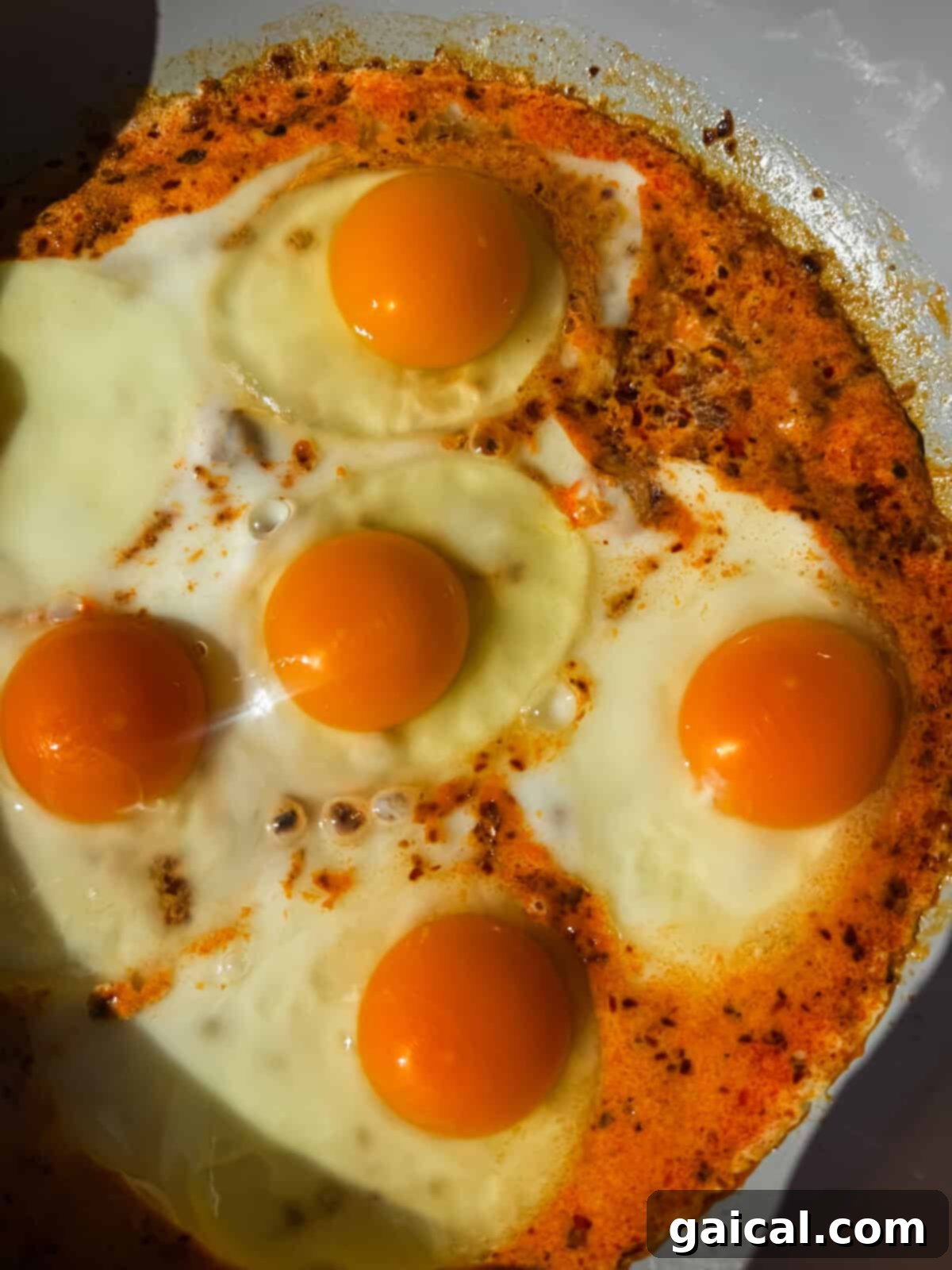Close-up of heavy cream fried eggs cooking in a pan