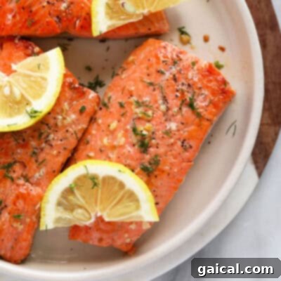 Raw salmon fillet on a plate, ready to be pan-seared to perfection.