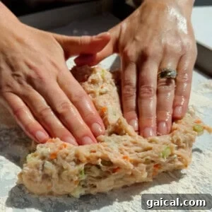 Buffalo Chicken Protein Bars — Crispy Baked Savory Snack 12 Pressing and shaping ground chicken protein bar mixture with vegetables on parchment paper