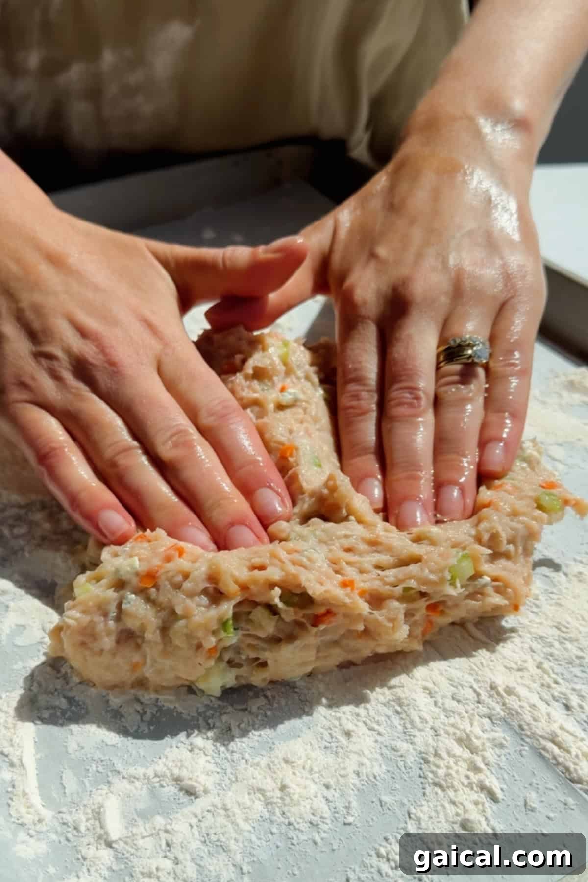 Buffalo Chicken Protein Bars — Crispy Baked Savory Snack 5 Pressing and shaping ground chicken protein bar mixture with vegetables on parchment paper