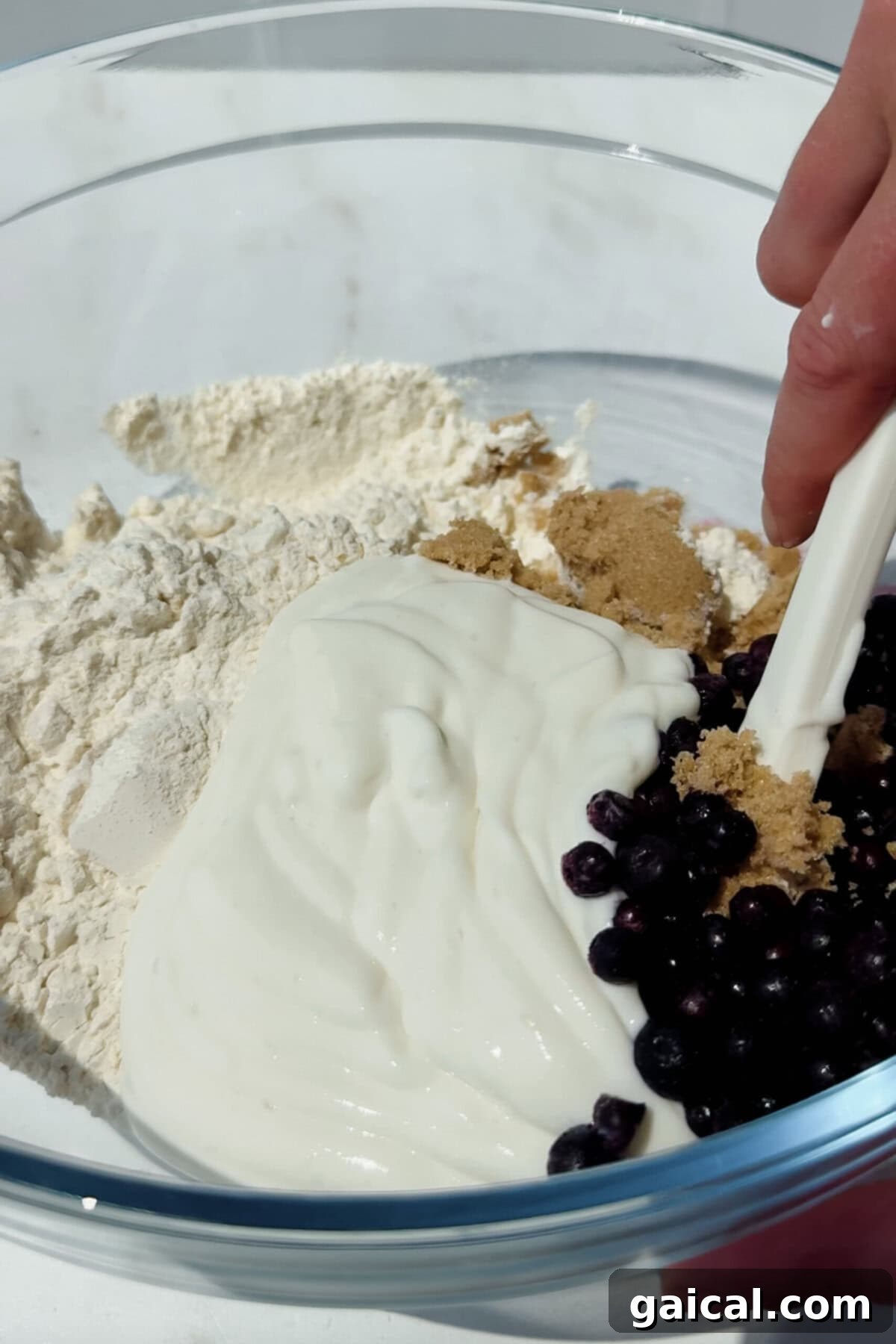 Warm Blueberry Cottage Cheese Biscuits with Streusel 3 mixing flour cottage cheese blueberries and brown sugar in a bowl for blueberry biscuits