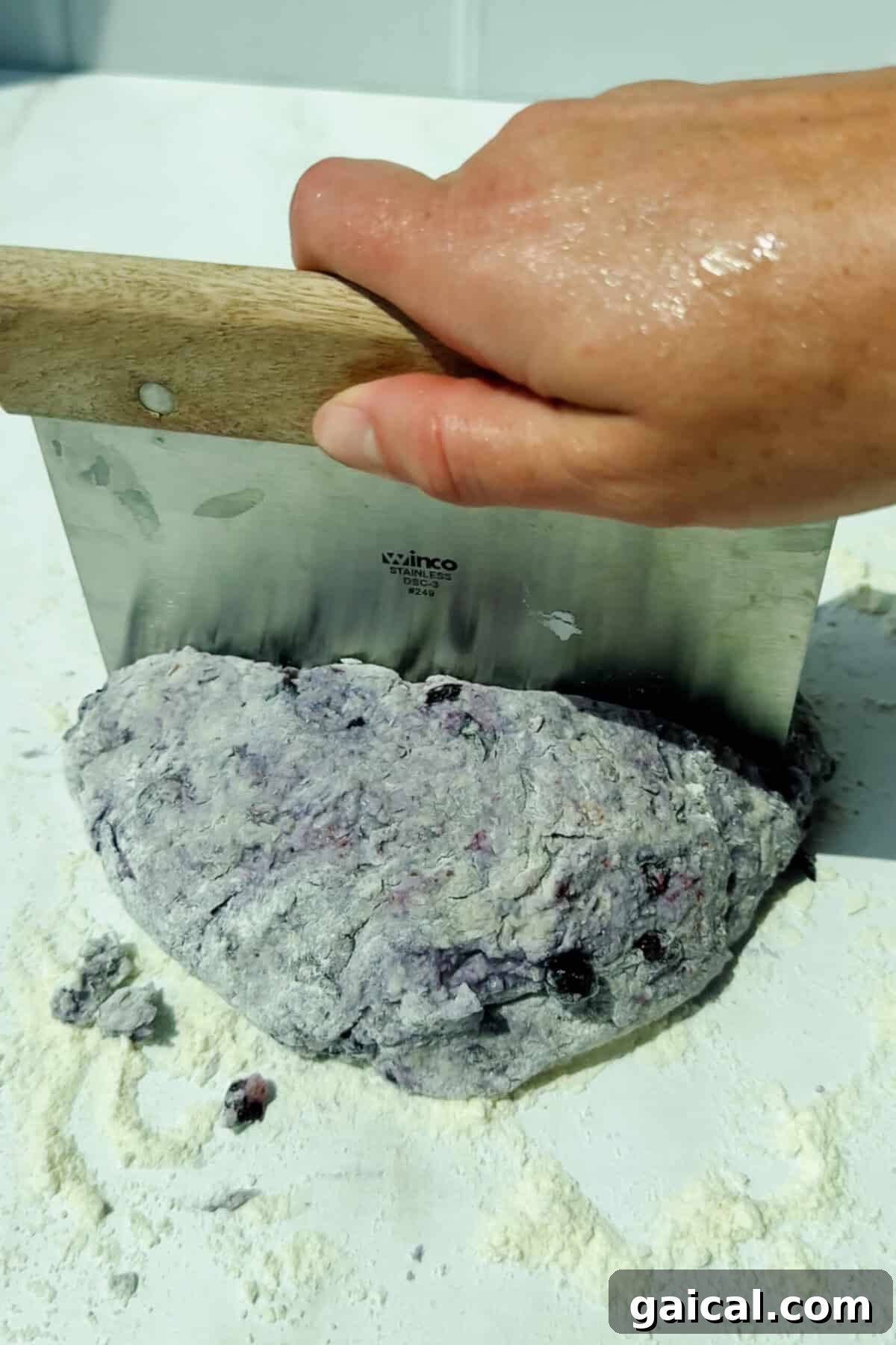 Warm Blueberry Cottage Cheese Biscuits with Streusel 4 cutting blueberry biscuit dough on a floured surface with a dough scraper