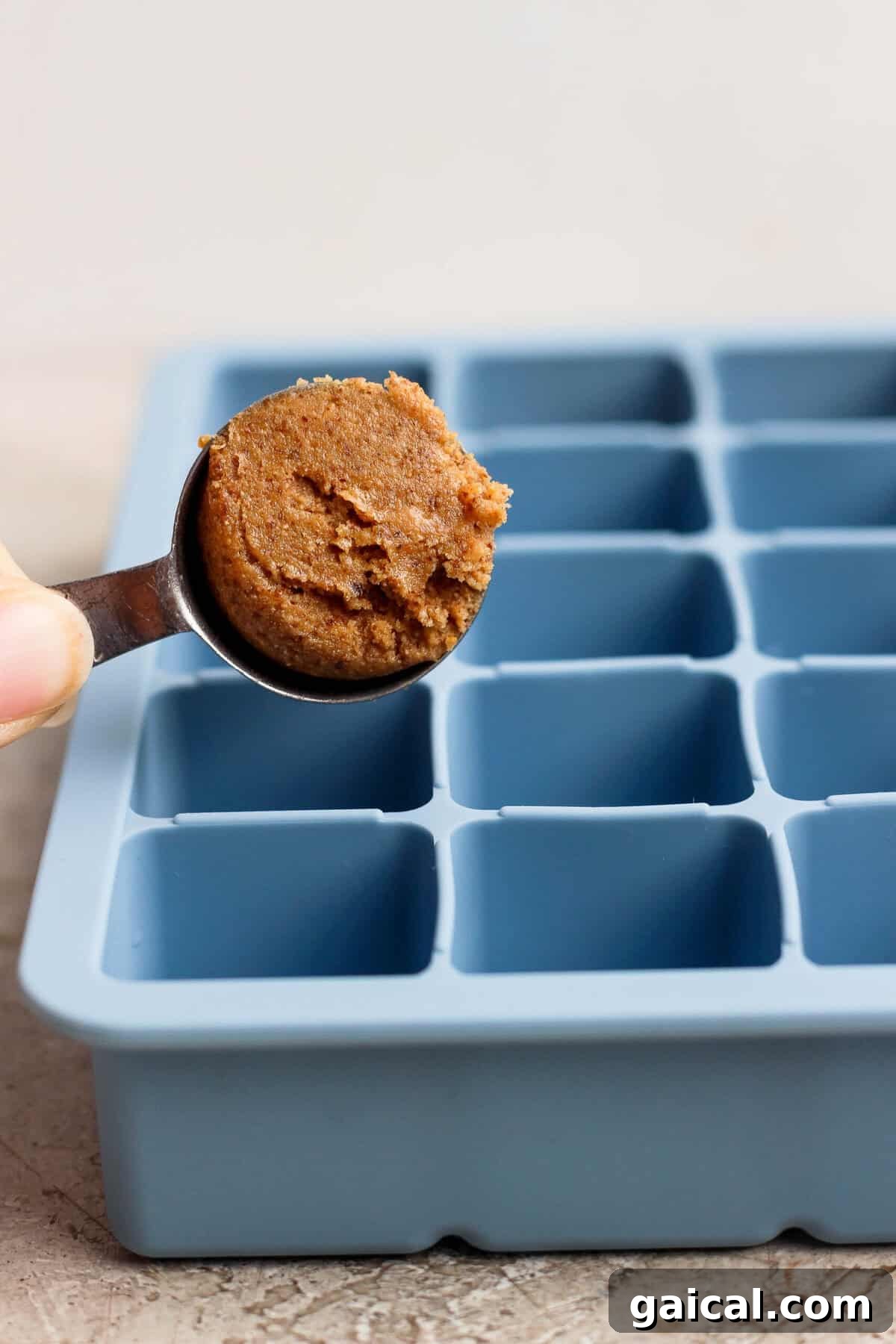 No-Bake Thin Mint Protein Bites 4 spooning protein bite mixture into a blue silicone ice cube tray