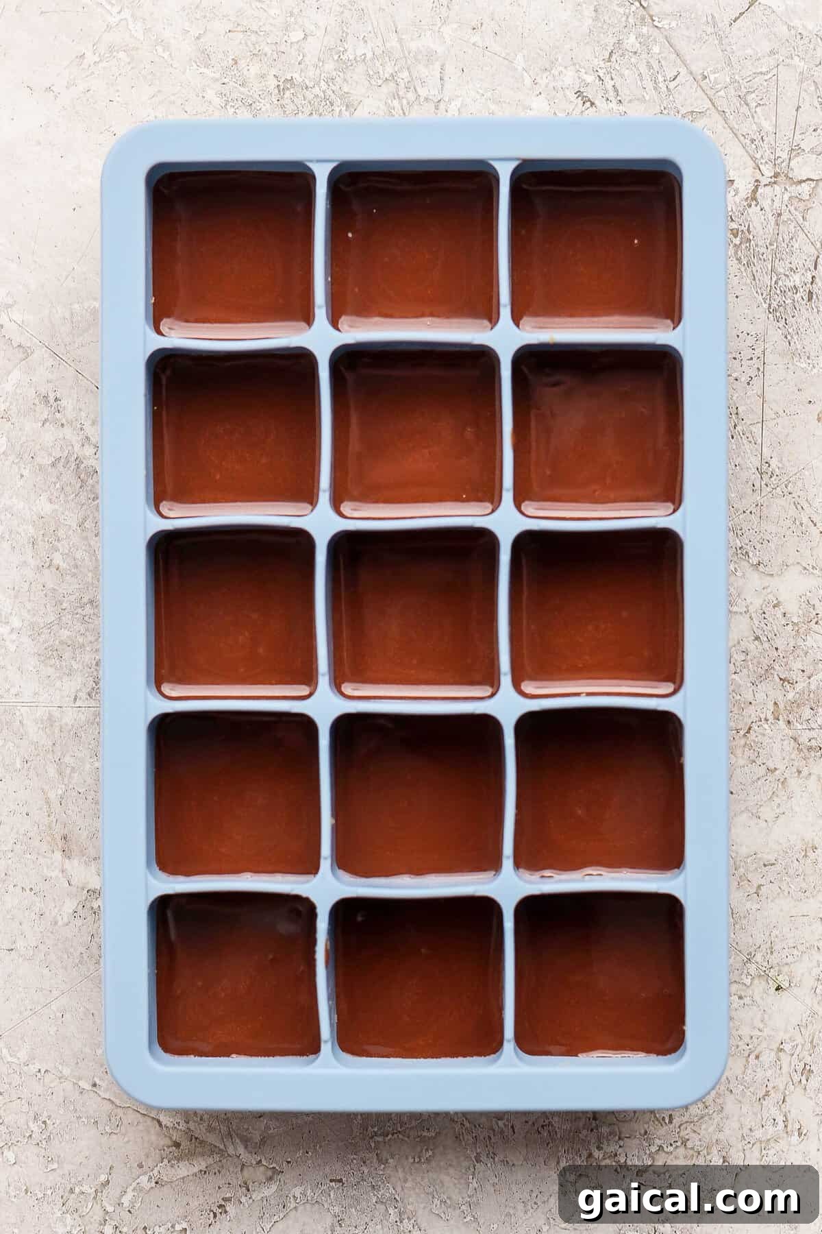 No-Bake Thin Mint Protein Bites 7 thin mint protein bites covered with melted chocolate layer in a blue silicone ice cube tray