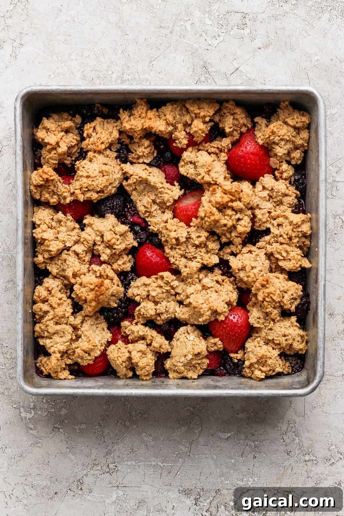 golden brown protein berry crumble fresh out of the oven in a baking pan